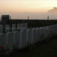 Misty sunrise over war military cemetery near Ploegsteert Wood - static real time