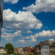 Fluffy clouds above Mouscron urban landscape near administration center - static time lapse