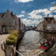 Bridges of Bruges :  Spiegelrei canal tour boats traffic in summer - static time lapse