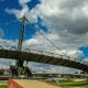 Kortrijk landscape : fluffy clouds above College footbridge and Buda Beach - static time lapse