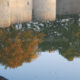 Water reflection of Ypres recently restored Lille Gate fortifications - dolly shot real time