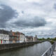 Quays and line of typical buildings alongside Scheldt river banks - static time lapse