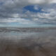 Sea, sand and clouds : the wide wide beach of De Panne at low tide - static time lapse