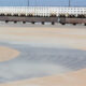 North Sea inspiring shot : sand blown alongside a curving walkway - static real time