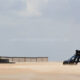 Sun, sand and fun : go kart riding on a belgian beach blown by wind - static real time