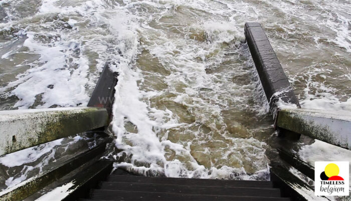 Waves crashing onto a wooden pier