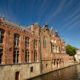 Buildings lining the Groenerei waterway in Bruges old historic town - static time lapse