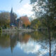 Bruges in autumn : Minnewater, Lake of Love and castle-restaurant - dolly shot real time