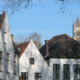 Typical white painted houses in the quietness of Bruges Beguinage - dolly shot real time