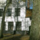 Whitewashed houses and central grass square of Bruges Begijnhof - dolly shot real time