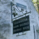 Iron wrought sign of Bruges Beguinage entrance : step back in time - dolly shot real time